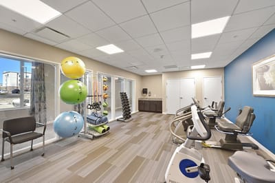 Fitness room with exercise equipment and colorful balls
