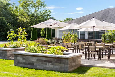 Outdoor seating area with umbrellas and gardens