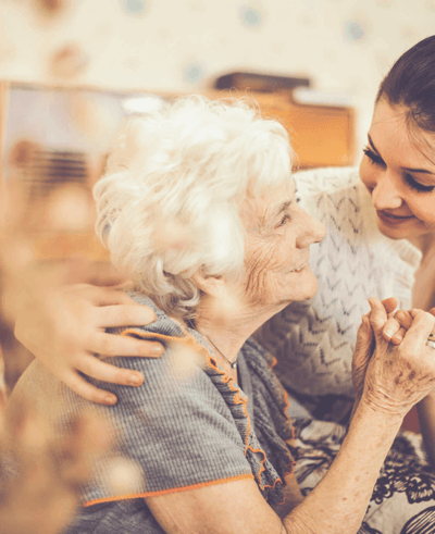 A caregiver interacting with an elderly resident