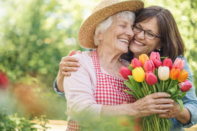 Residents enjoying time in the garden with tulips