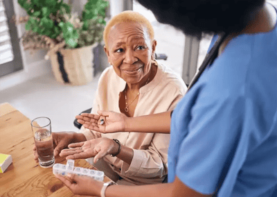 Caregiver assisting a resident with medication