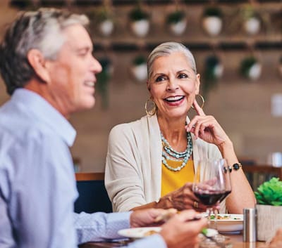 Two residents enjoying a meal together in a dining area