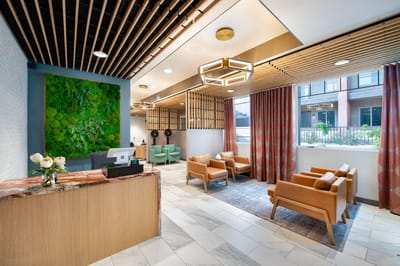 Modern lobby area with seating and greenery