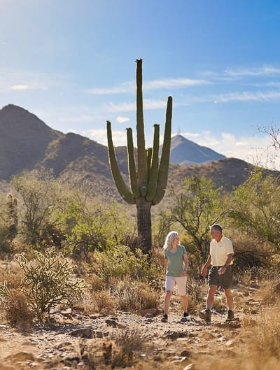 Two seniors enjoying a walk in a desert landscape