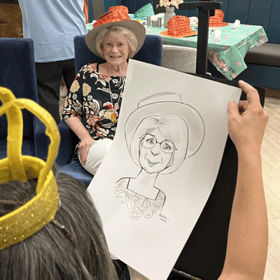 Resident enjoying a caricature drawing activity