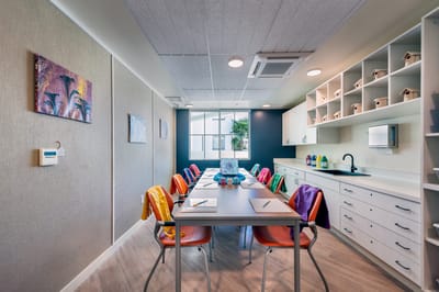 Bright and modern activity room with a large table