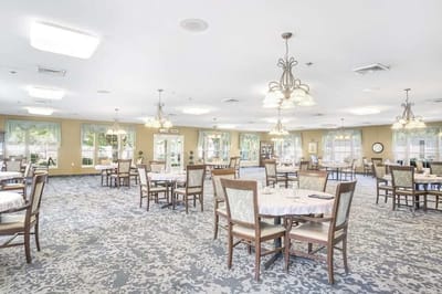 Bright and spacious dining room with tables and chairs