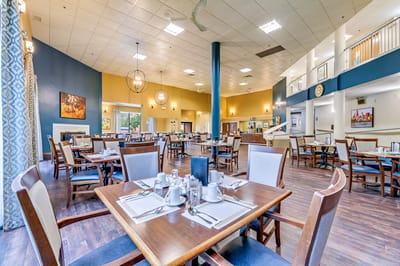 Bright dining room with tables set for meals