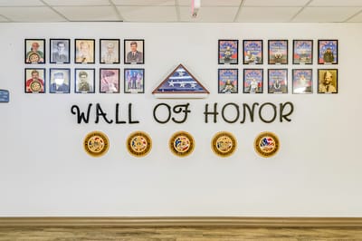 Wall of honor displaying photos and awards