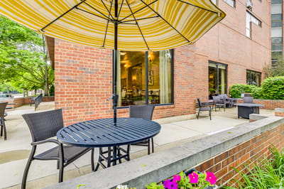 Outdoor seating area with flowers and building facade