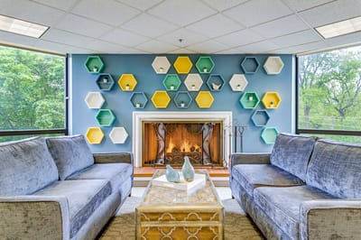 Comfortable seating area with decorative wall and fireplace