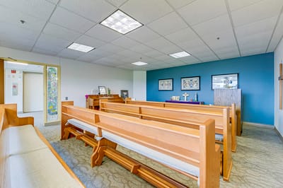 Interior view of a common area with wooden benches