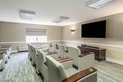 Interior lounge area with seating and large screen
