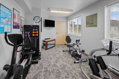 Bright fitness room with exercise equipment