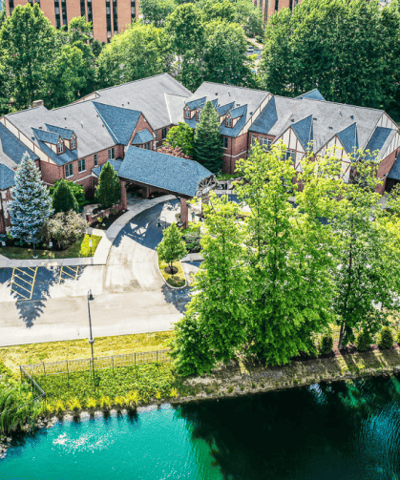Aerial view of a senior living facility surrounded by greenery