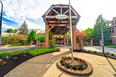 Entrance of a senior living facility with flower beds