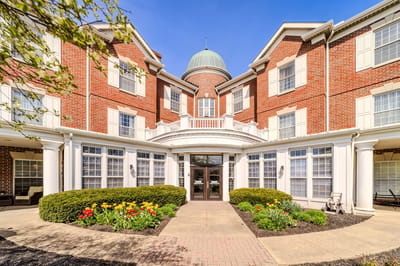 Exterior view of a senior living facility with gardens