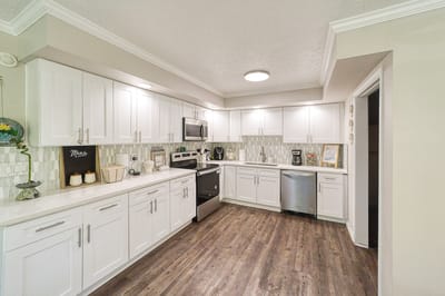 Modern kitchen interior with white cabinets and appliances