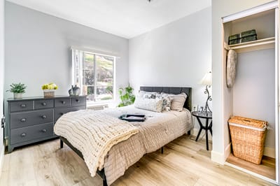 Cozy bedroom setup with natural light and furniture