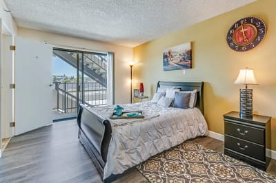 Brightly decorated resident bedroom with natural light