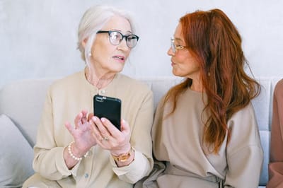 Two women engaged in conversation on a couch