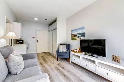 Cozy interior of a resident's room with a TV and seating.