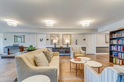 Interior common area with seating and bookshelf