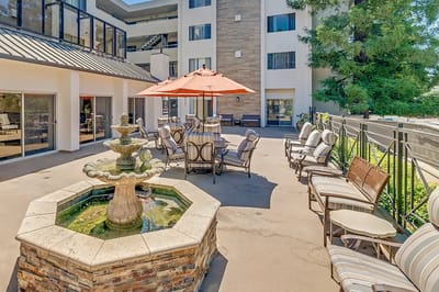 Outdoor seating area with a fountain and umbrellas