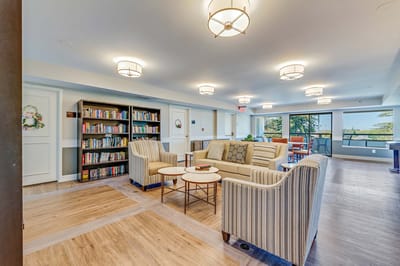 Bright common area with seating and bookshelf
