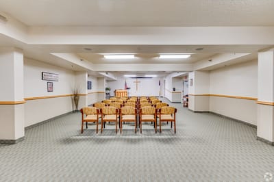 Bright common area with seating and a cross.