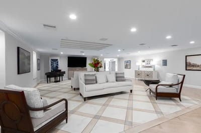 Bright common area with seating and piano
