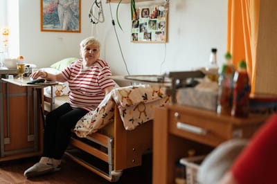Resident sitting in their room with personal items