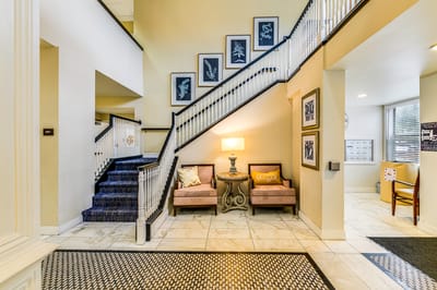 Bright lobby area with staircase and seating