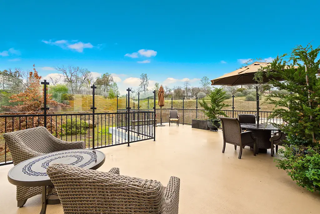 Outdoor patio area with seating and landscaping