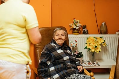 Resident sitting in a cozy lounge area