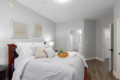 Bright and welcoming resident room with a bed and decor
