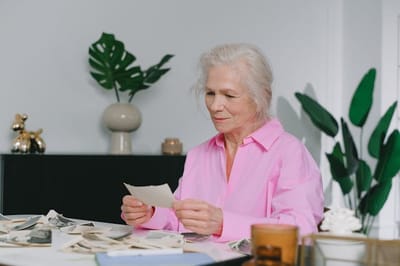 Senior woman looking at photographs in a cozy room