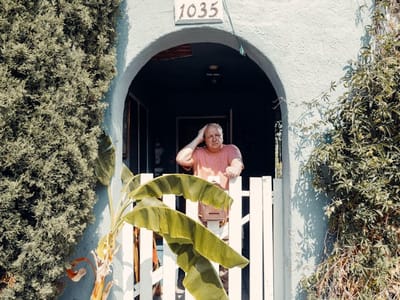 A resident standing at the entrance of the facility