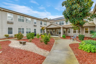 Garden area with pathways and seating in a senior living facility