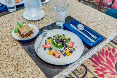 Well-presented meal with dessert in a dining setting