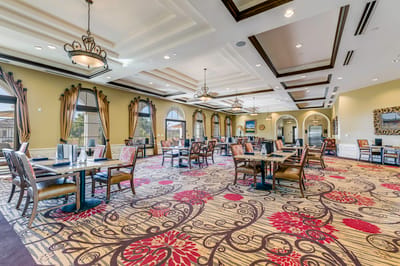 Elegant dining room with large windows and decorative chairs