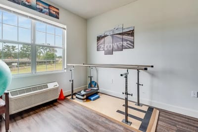 Physical therapy space with parallel bars and equipment