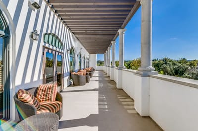 A sunny outdoor patio area with comfortable seating