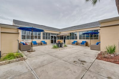 Outdoor seating area with blue umbrellas and couches