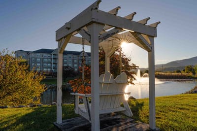 Outdoor gazebo with a scenic pond and sunset view