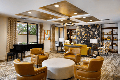 Bright common area with comfortable seating and bookshelves