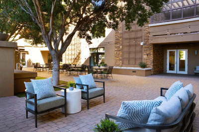 Outdoor seating area with patio furniture and landscaping