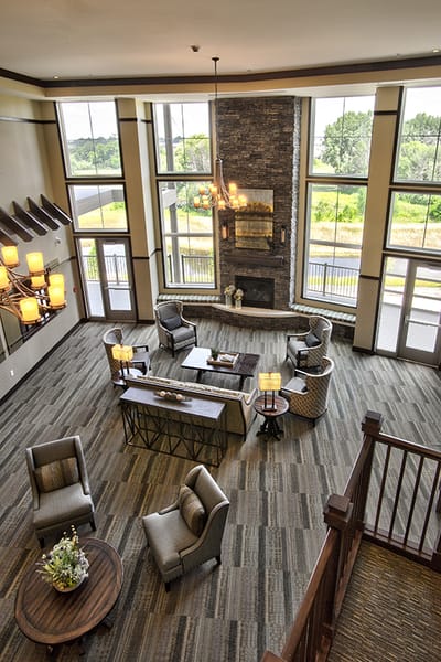 Bright and spacious common area with fireplace and seating