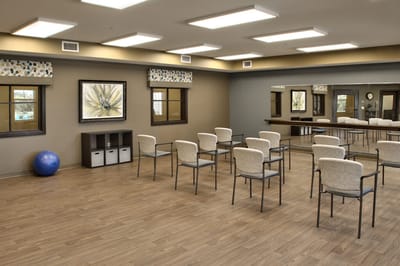 Bright activity room with chairs arranged in rows