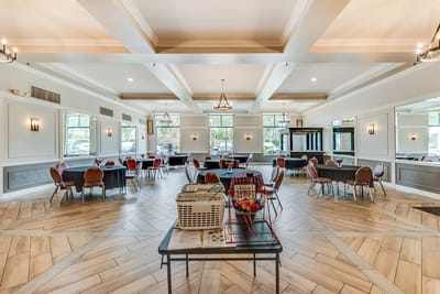 Bright common area with tables and chairs arranged